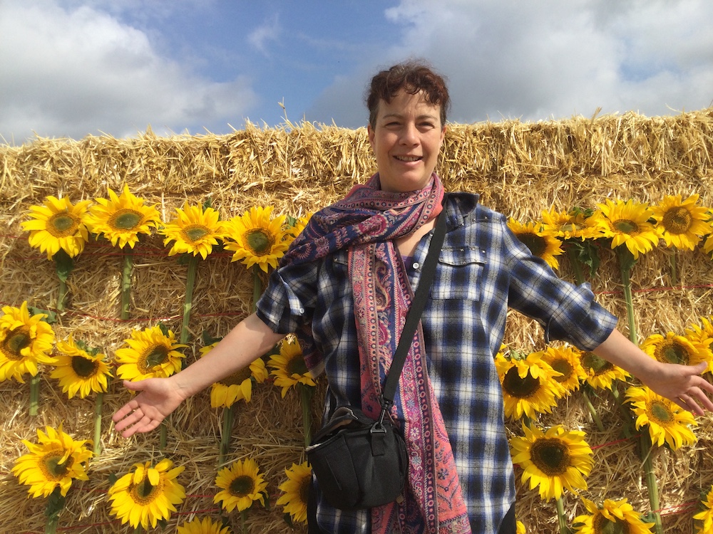 Ruth (English Teacher) with sunflowers - taken at Gloagburn Farm, smiling at camera