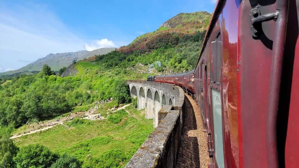 The Jacobite steam train on the Glennfinnan viaduct - best train journey in Scotland Harry Potter train