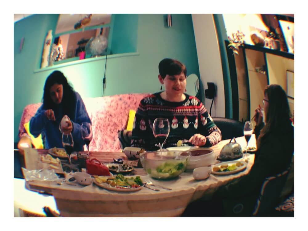 eating raclette cheese dinner at our language school Christmas party, with Christmas jumper