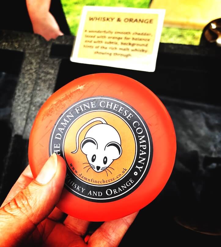 hand holding local handmade cheese for language school in scotland food and drink. Learn English in Scotland