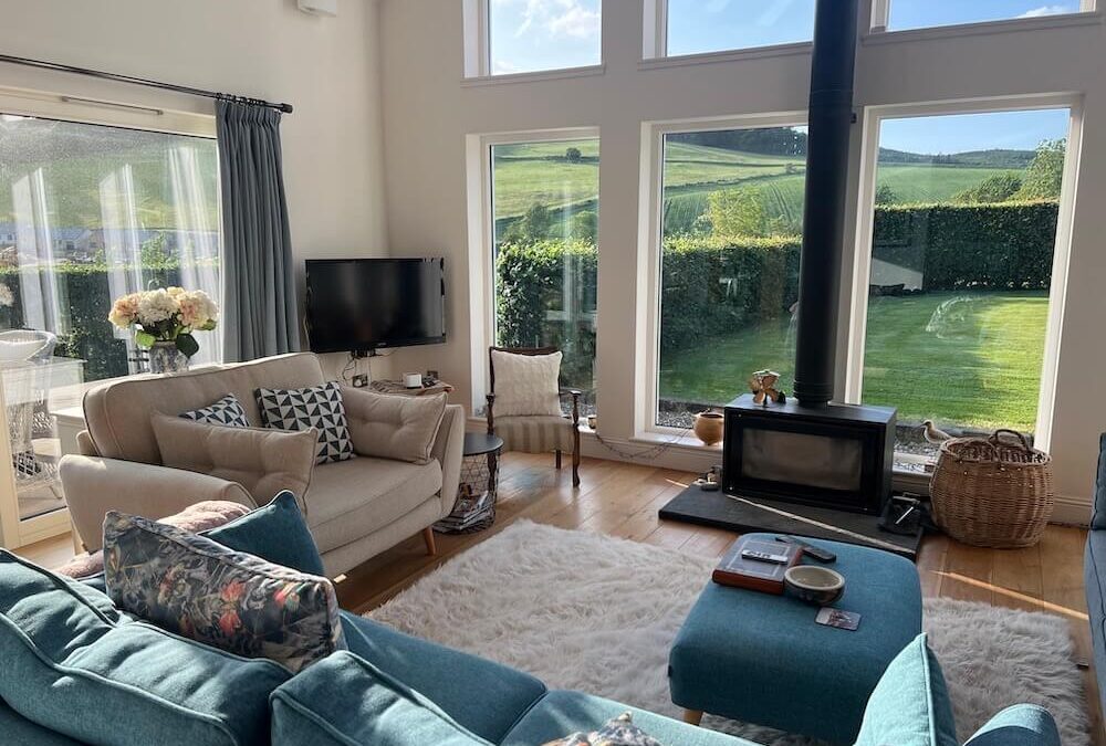 How to enjoy your language Homestay in the UK. Photo of host sitting room with garden and stove.