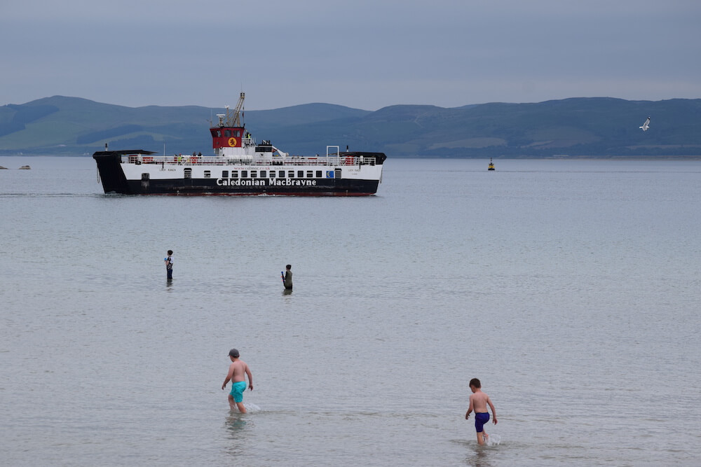 August language holiday - Scottish ferry in bay beside island