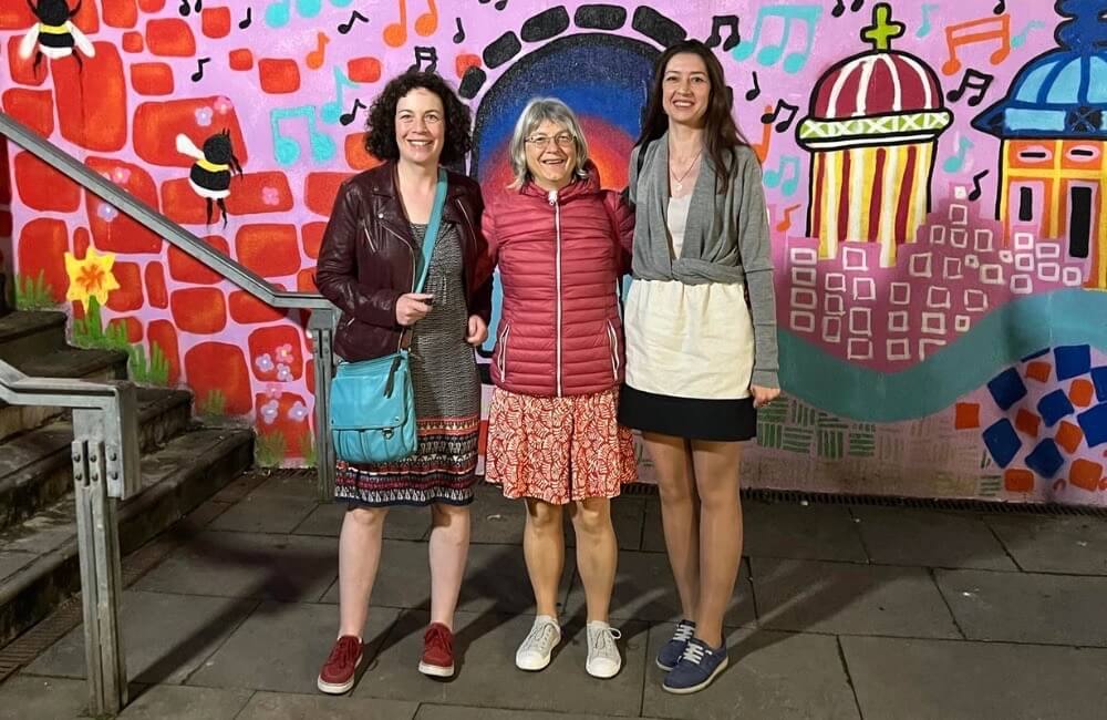 Senior language holiday music event at Stirling Tollbooth theatre - graffiti wall in background real world english practice