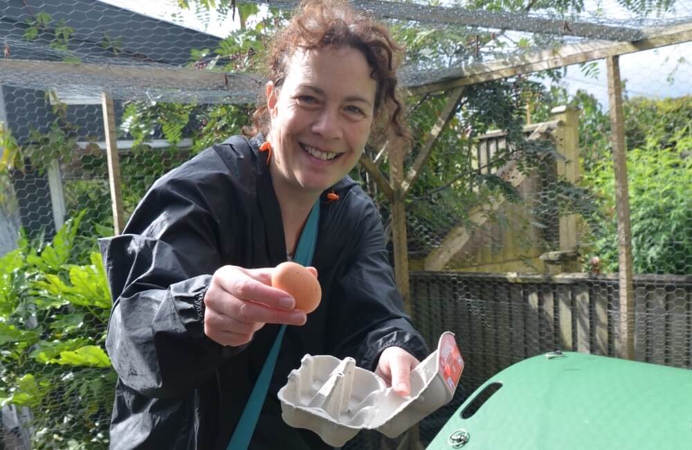 Ruth Pringle holding freshly collected free-range eggs at a homestay during an English holiday