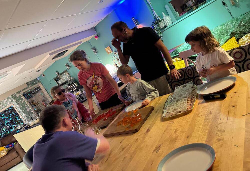Ruth Pringle making jelly with a child during a family English holiday experience in Scotland