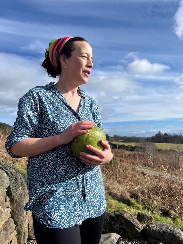 Ruth Pringle sharing an unusual fruit with guests during a picnic on a hillside in Scotland