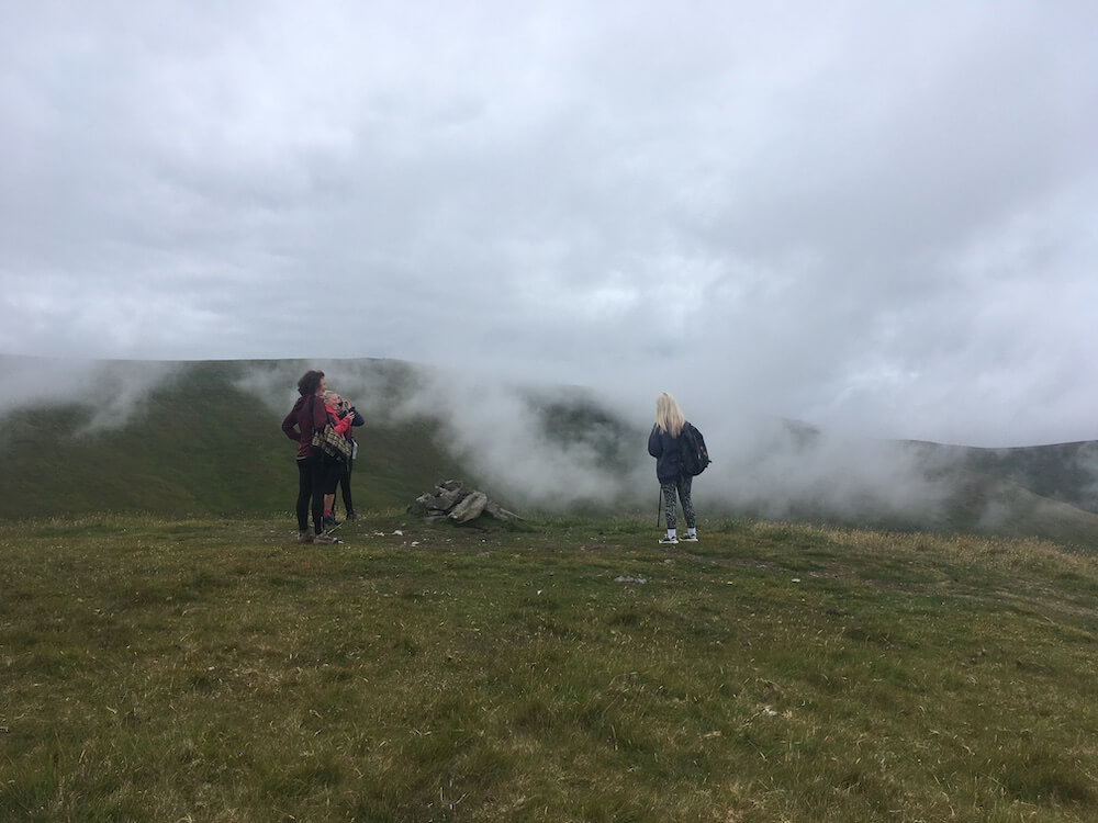 Small group on a guided nature walk in Perthshire with an expert wildlife guide in the mist