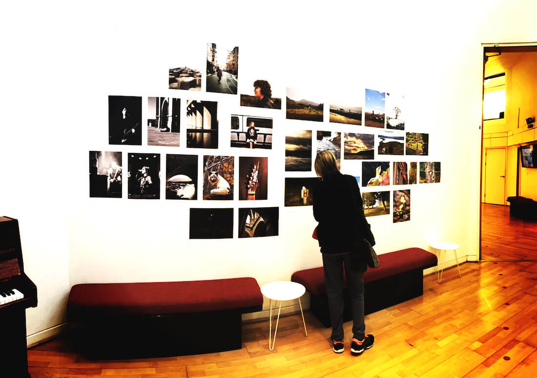 Photography students’ work displayed together on a wall at the University of Stirling, used as a Conversation Wall for English discussion.