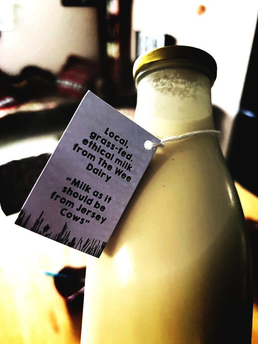 bottle of local milk with grass fed, ethical label