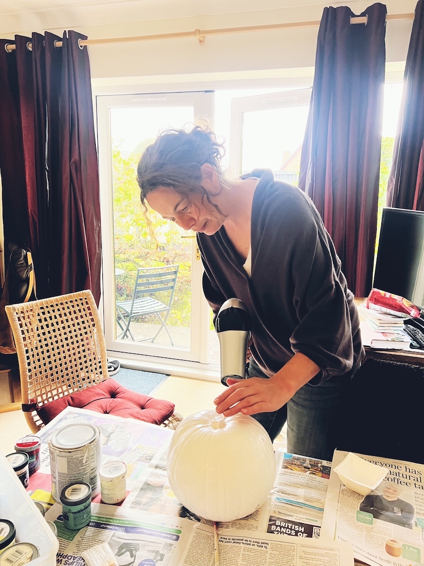 Ruth painting a pumpkin during a family autumn English holiday in Scotland